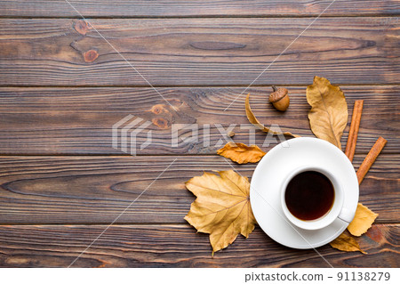 Flat lay composition with colorful Autumn cup of coffee and leaves on a color background. top view 91138279