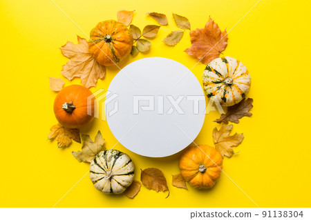 Autumn composition with round paper blank and dried leaves with pumpkin on table. Flat lay, top view, copy space Autumn composition with round paper blank and dried leaves with pumpkin on table. Flat lay, top view, copy space 91138304