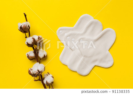 set of colorful bright reusable menstrual pads with cotton flower. zero waste woman periods concept top view with copy space set of colorful bright reusable menstrual pads with cotton flower. zero waste woman periods concept top view with copy space 91138335