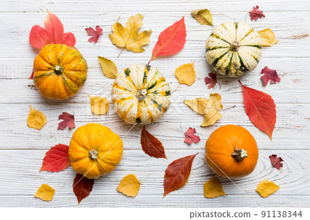 Autumn composition. Pattern made of dried leaves and other design accessories on table. Flat lay, top view Autumn composition. Pattern made of dried leaves and other design accessories on table. Flat lay, top view 91138344