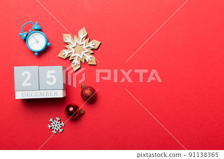 Christmas wood calendar with new year decorations, aganist colored background. Christmas calendar 25 desember 91138365