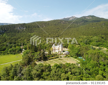 Massandra Palace of Emperor Alexander III is located in the Upper Massandra on the southern coast of Crimea. Summer green park museum. Renaissance architectural monument. Manor castle Aerial View 91139145