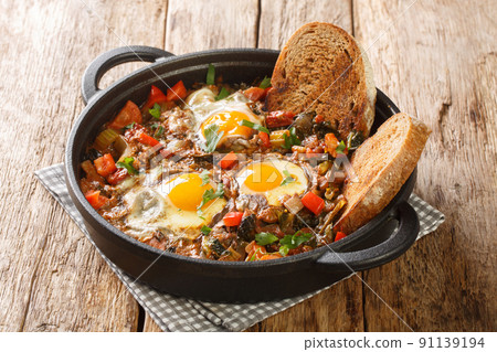 Tasty vegetable soup with eggs Acquacotta served with homemade bread close-up in a bowl. horizontal 91139194