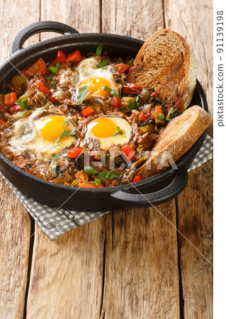 Italian thick vegetable soup Acquacotta Maremmana served with homemade bread close-up in a saucepan. vertical 91139198