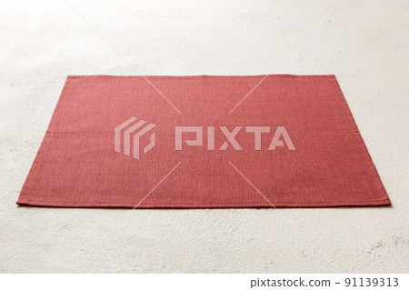 Perspective view of red tablecloth for food on cement background. Empty space for your design 91139313