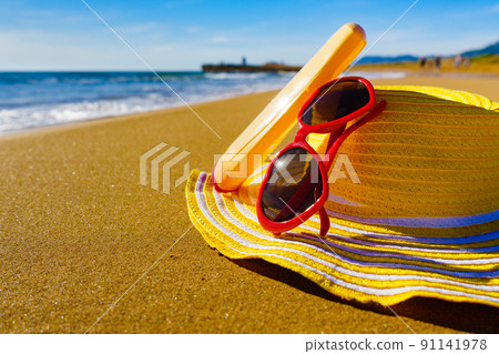 Sun protection gear on sand beach Sun protection gear on sand beach 91141978