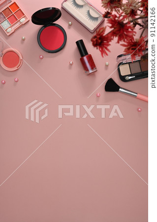 Top view female workspace with makeup brushes, cosmetics and flowers on pink background. Copy space for your text Top view female workspace with makeup brushes, cosmetics and flowers on pink background. Copy space for your text 91142166
