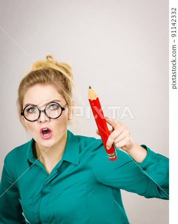 Angry teacher woman holding big pencil Angry teacher woman holding big pencil 91142332