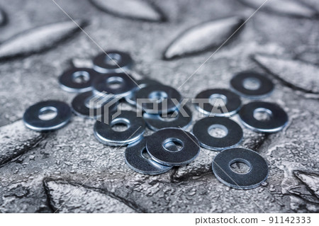 PIle of shiny screw washers. PIle of shiny screw washers. 91142333