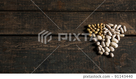 Legumes (beans). several types of dried beans. White and green beans on a wooden texture. Food. Close. White beans green beans. Brazilian diet snack. Concept Legumes (beans). several types of dried beans. White and green beans on a wooden texture. Food. Close. White beans green beans. Brazilian diet snack. Concept 91143440
