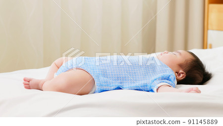 baby sleeping on the bed baby sleeping on the bed 91145889