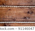 detail view of wooden wall decorated with jute rope 91146047