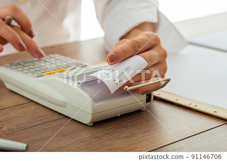 Female hands using adding machine 91146706