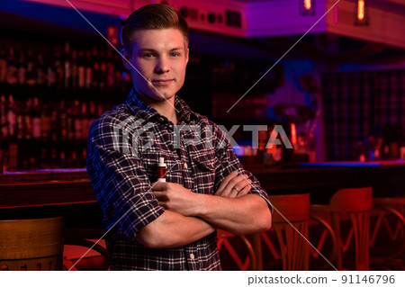 The man smoke an electronic cigarette at the vape shop. 91146796
