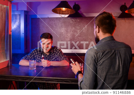 Vaping man holding a mod. A cloud of vapor at the vapebar. 91146886