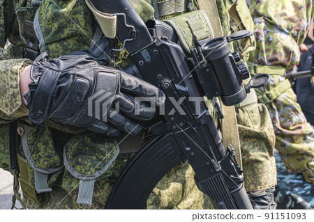 Armed soldier holding a rifle with a scope 91151093