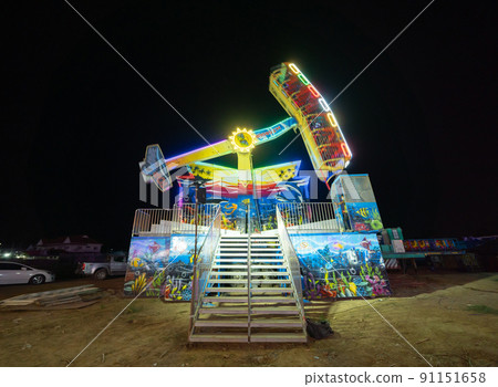 The amusement park in Thai traditional night temple fair in Bangkok City, Thailand. Local market street food festival. 91151658