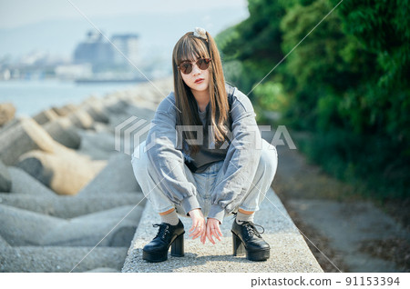 Gen Z woman sitting looking at the camera 91153394