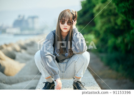 Gen Z woman sitting looking at the camera 91153396