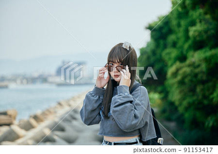 Gen Z women standing looking at the camera 91153417