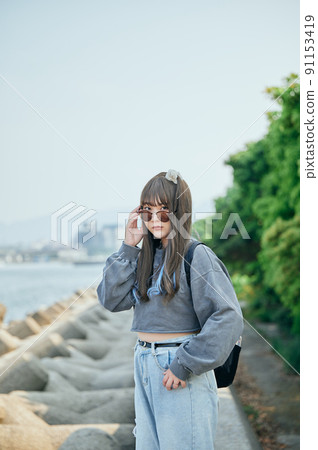 Gen Z women standing looking at the camera 91153419