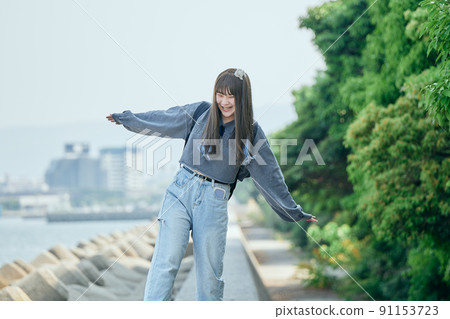 Gen Z women walking along the coast Gen Z women walking along the coast 91153723