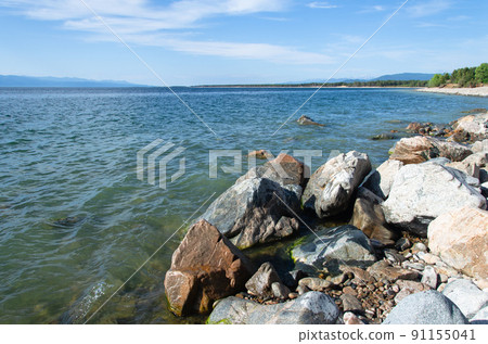 Stones on the shore of Lake Baikal in sunny summer weather. 91155041