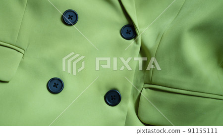 Light green jacket blouse with black buttons closeup 91155111