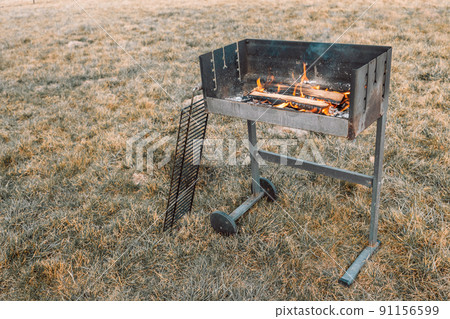 bbq grill flame, hot burning grill, outdoors cooking food. Grill flame burning fire for barbecue cooking outdoors. bbq grill flame, hot burning grill, outdoors cooking food. Grill flame burning fire for barbecue cooking outdoors. 91156599