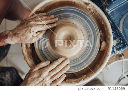 Flat Lay of Potter Master at Work in Clay Studio, Handmade Process of Creating Pot on a Pottery Wheel Flat Lay of Potter Master at Work in Clay Studio, Handmade Process of Creating Pot on a Pottery Wheel 91158069