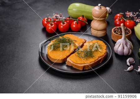 Delicious squash caviar sandwiches on a dark concrete background, healthy breakfast Delicious squash caviar sandwiches on a dark concrete background, healthy breakfast 91159906