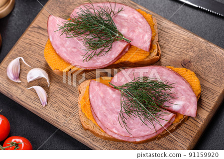 Delicious squash caviar sandwiches on a dark concrete background, healthy breakfast 91159920