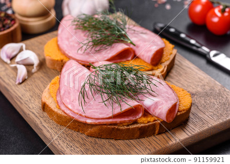 Delicious squash caviar sandwiches on a dark concrete background, healthy breakfast Delicious squash caviar sandwiches on a dark concrete background, healthy breakfast 91159921