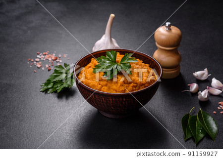 Squash caviar with garlic and tomatoes in a rustic bowl on a dark background 91159927