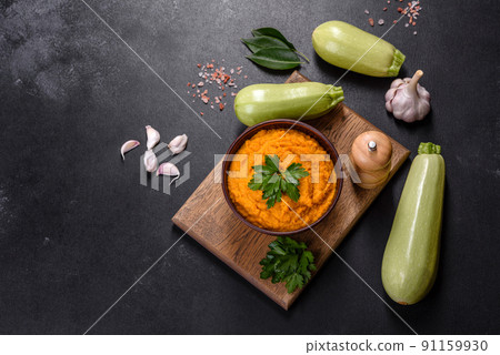 Squash caviar with garlic and tomatoes in a rustic bowl on a dark background 91159930