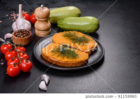 Delicious squash caviar sandwiches on a dark concrete background, healthy breakfast Delicious squash caviar sandwiches on a dark concrete background, healthy breakfast 91159960
