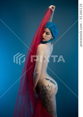 a naked girl with a beautiful sexy figure is covered with a transparent red cloth on a blue background a naked girl with a beautiful sexy figure is covered with a transparent red cloth on a blue background 91160119