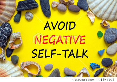 Avoid negative self-talk symbol. Concept words Avoid negative self-talk on a beautiful yellow background. Sea stones and seashells. Psychological and Avoid negative self-talk concept. Copy space. 91164591