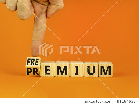 Premium or freemium symbol. Businessman turns wooden cubes and changes the concept word Premium to Freemium. Beautiful orange table orange background. Business premium or freemium concept. Copy space. Premium or freemium symbol. Businessman turns wooden cubes and changes the concept word Premium to Freemium. Beautiful orange table orange background. Business premium or freemium concept. Copy space. 91164633