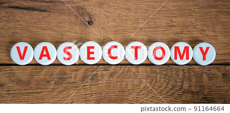Vasectomy symbol. Concept words Vasectomy on white circles. Beautiful wooden table wooden background. Medical and vasectomy problem concept. Conceptual image. Copy space. 91164664