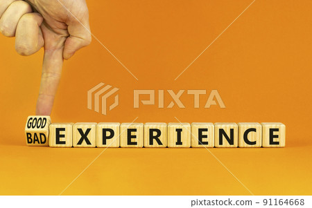 Good or bad experience symbol. Businessman turns a wooden cube, changes words bad experience to good experience . Beautiful orange background, copy space. Business, good or bad experience concept. 91164668
