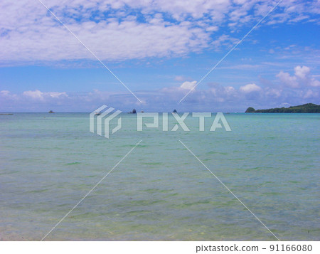 A ship floating in the blue sky and calm sea on a sunny day 91166080