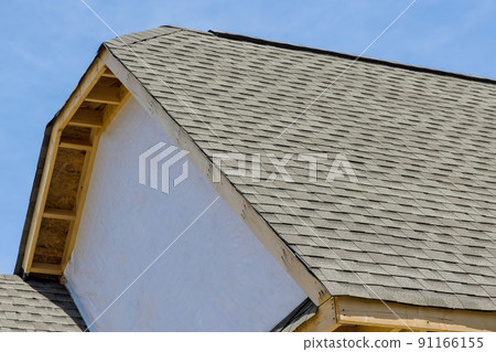 Roofing waterproofing for a new house with asphalt shingles in a covered corner on a building 91166155