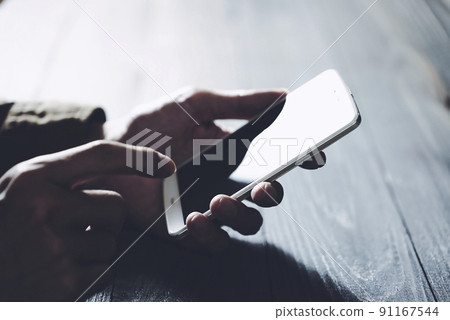 Man looking at a smartphone Man looking at a smartphone 91167544