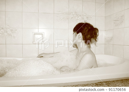 Bath time The figure of a woman taking a bath Bath time The figure of a woman taking a bath 91170656