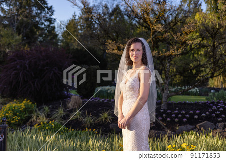 White Caucasian Adult Woman in a Wedding Dress standing outside in nature White Caucasian Adult Woman in a Wedding Dress standing outside in nature 91171853