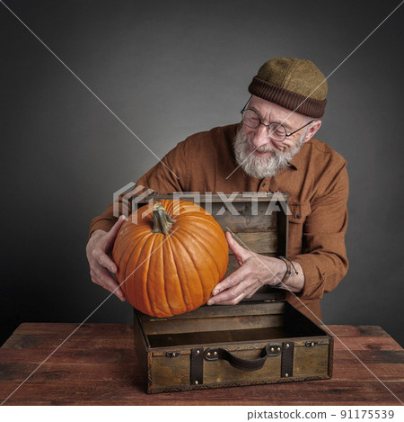 smiling senior man with pumpkin smiling senior man with pumpkin 91175539