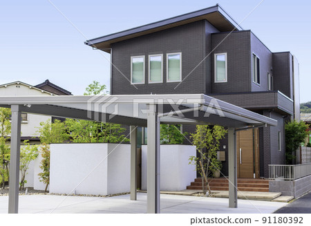 Exterior and sky of a house with a carport 91180392