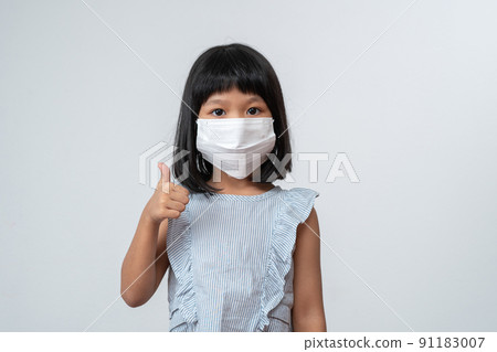 Portrait of Asian girl kid with protective face mask ready for new school year with pandemic restrictions. Concept of kid going back to school and new normal lifestyle Portrait of Asian girl kid with protective face mask ready for new school year with pandemic restrictions. Concept of kid going back to school and new normal lifestyle 91183007