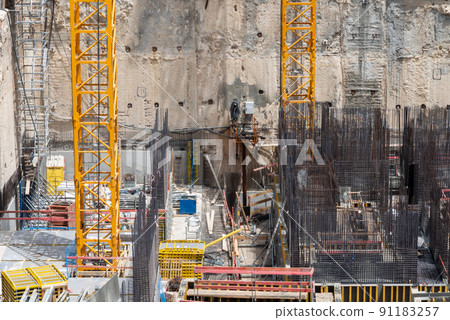 Construction site background. Hoisting cranes and new multi storey buildings. Industrial background. Close Up of Somail complex in Tel Aviv Construction work on the new Tel Aviv Municipality building Construction site background. Hoisting cranes and new multi storey buildings. Industrial background. Close Up of Somail complex in Tel Aviv Construction work on the new Tel Aviv Municipality building 91183257